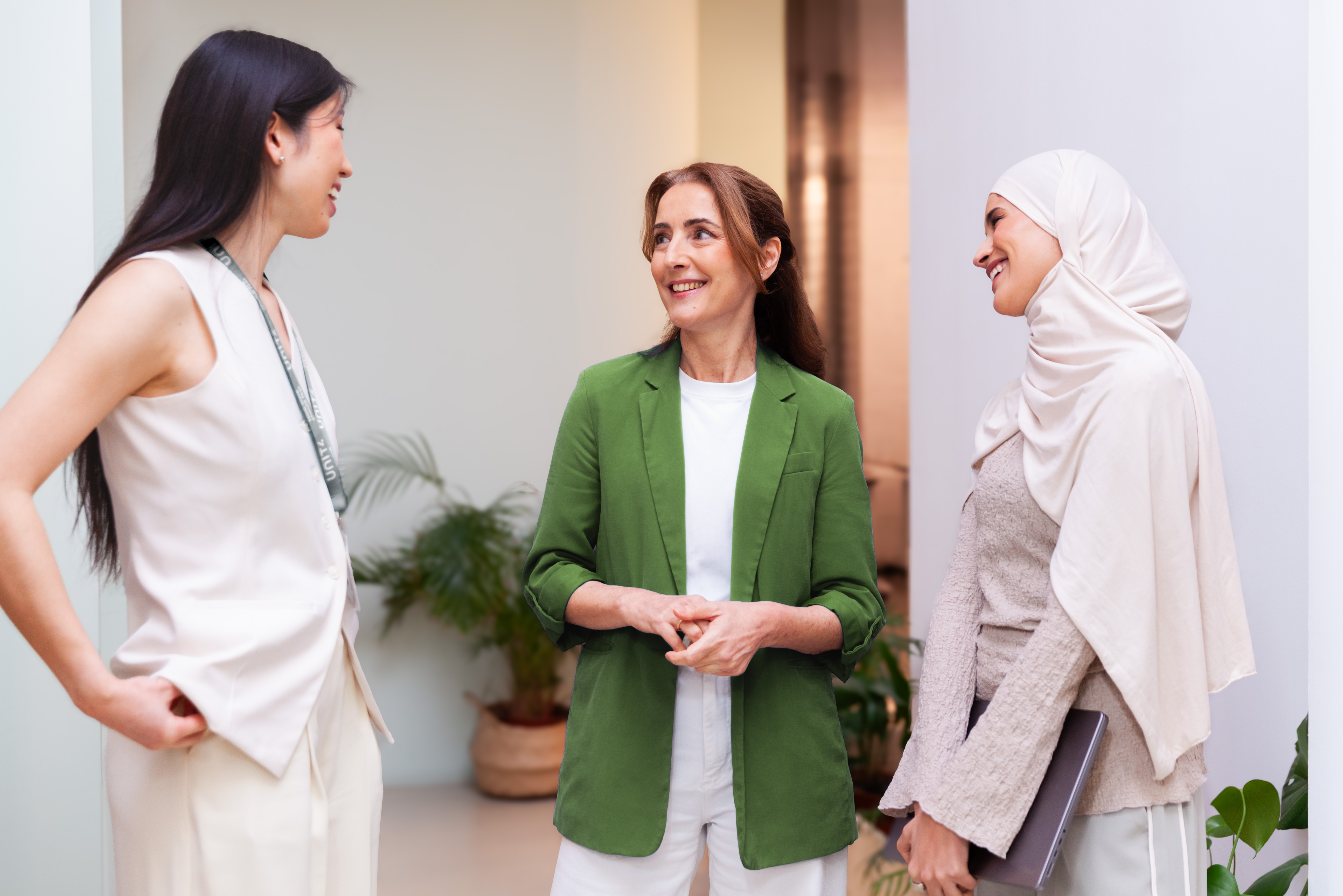 Three colleagues having a conversation in an office