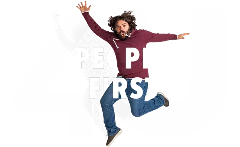 Man jumping up in front of the People First logo