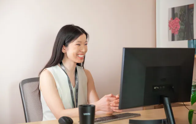 Person talking and smiling to computer 